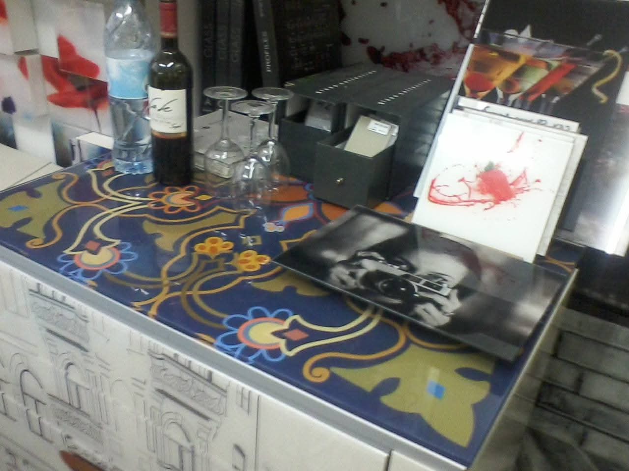 Artworks and materials across a workshop desk